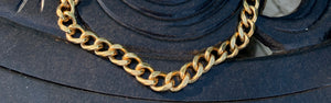 Inch of Gold large Cuban curb necklace on black table
